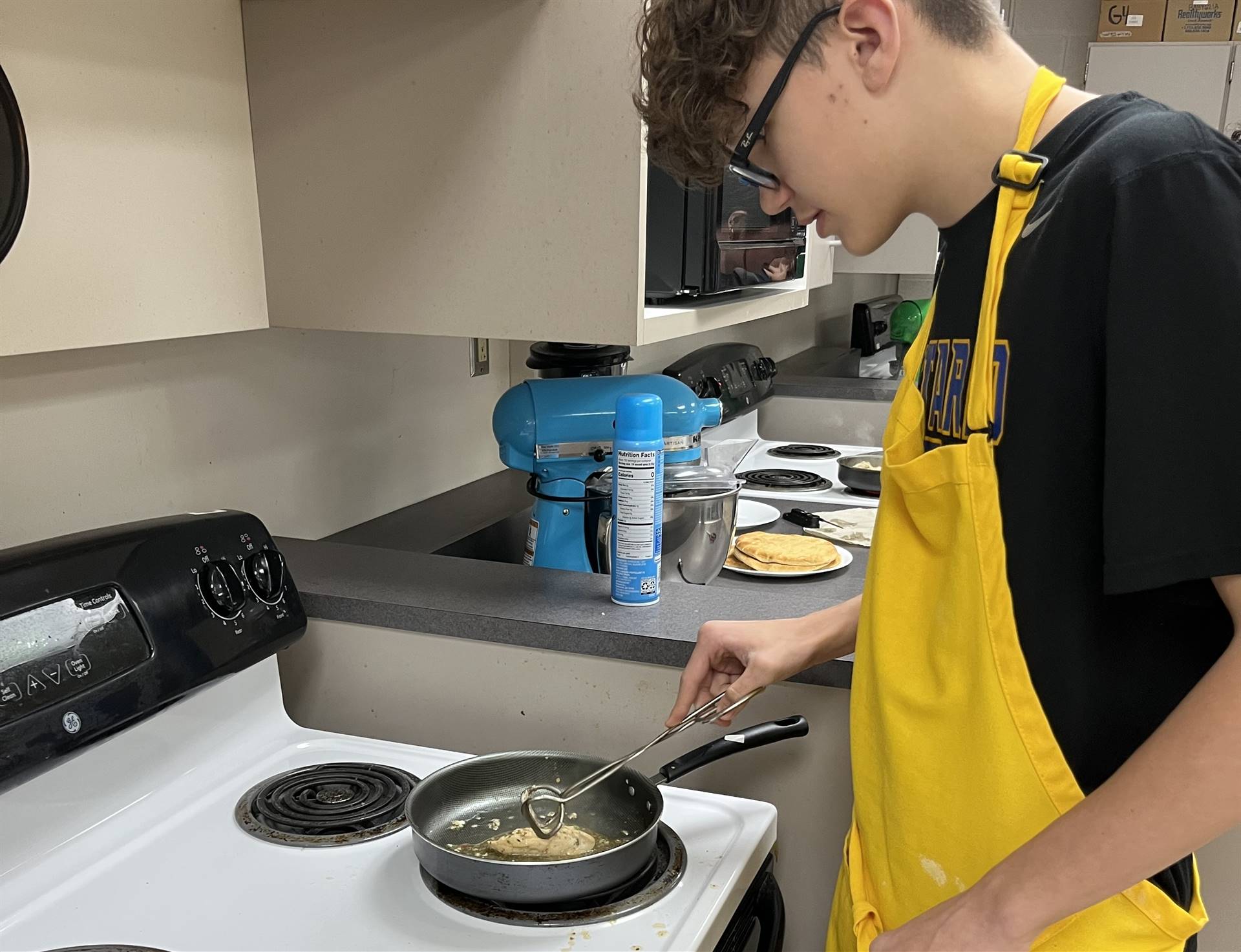 student at stove